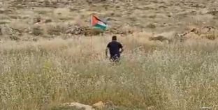 إسرائيلي حاول إزالة علم فلسطين المغروس على الأرض