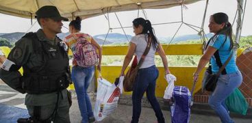 نساء يعبرن الحدود بين فنزويلا وكولومبيا