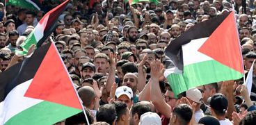 فلسطينيون يلوحون بالأعلام- ارشيفية