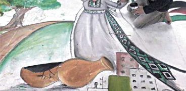 «مؤمن» يرسم سيدة ترقص بالزى الفلسطينى المميز