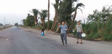 شباب بنى سويف على الطريق يمسكون بالعصائر والتمر لتوزيعها على المسافرين