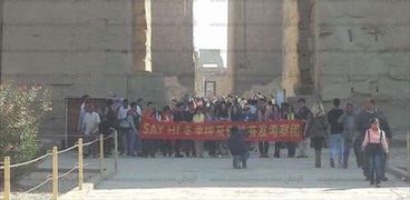 صينيون يرفعون لافتة " الشعب الصيني يدعوا العالم لزيارة الأقصر"