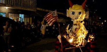 حرق تمثال من الورق يمثل ترامب