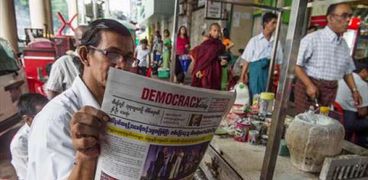 أحد المواطنين في بورما يقرأ الصحفية التي تصدر "ترامب"في صفحتها الأولى