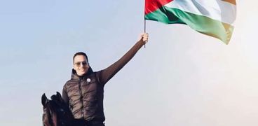 عصام السقا حاملًا علم فلسطين