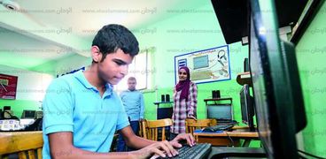 أحد تلاميذ المدرسة أثناء استخدامه جهاز الكمبيوتر