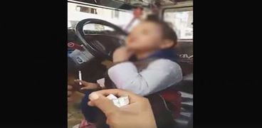 طفل يدخن سيجارة ويمسك بسلاح أبيض
