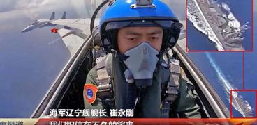 الطائرة المقاتلة الصينية تحلق فوق المدمرة الأمريكية