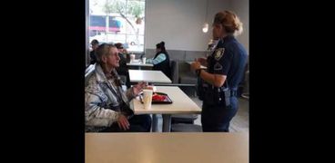 شرطية تمنع متشرد من تناول الطعام