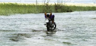 شاب يظهر مسترخيا فوق دراجتة على سطح الماء